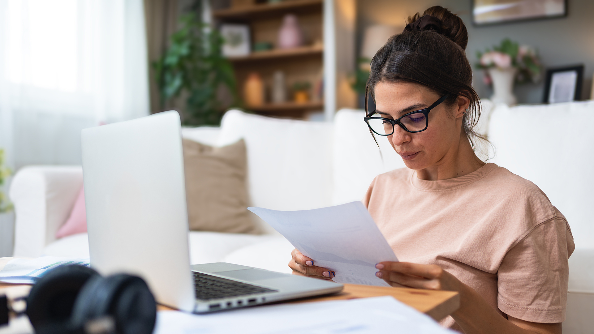 Young woman freelance worker small startup company business owner calculating tax return with data on laptop computer