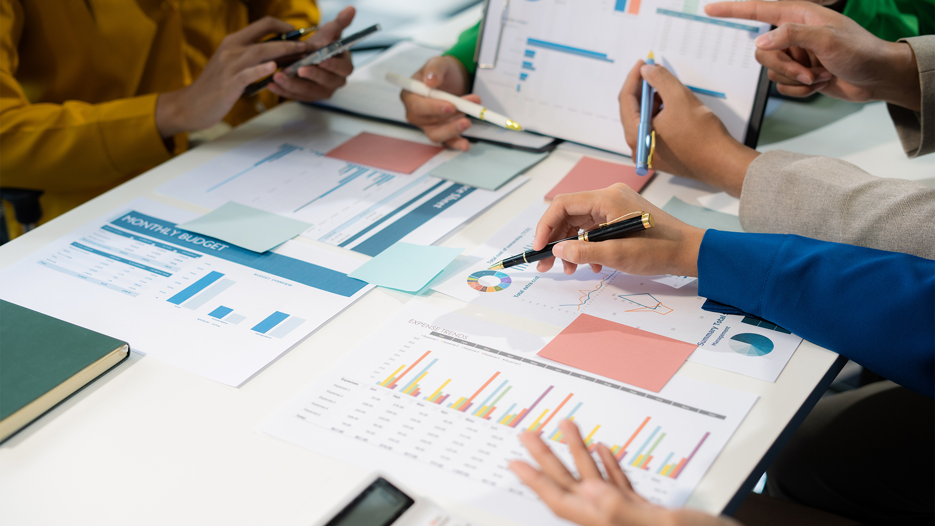 financial advisor showing plan of investment to clients in the consultancy office.
