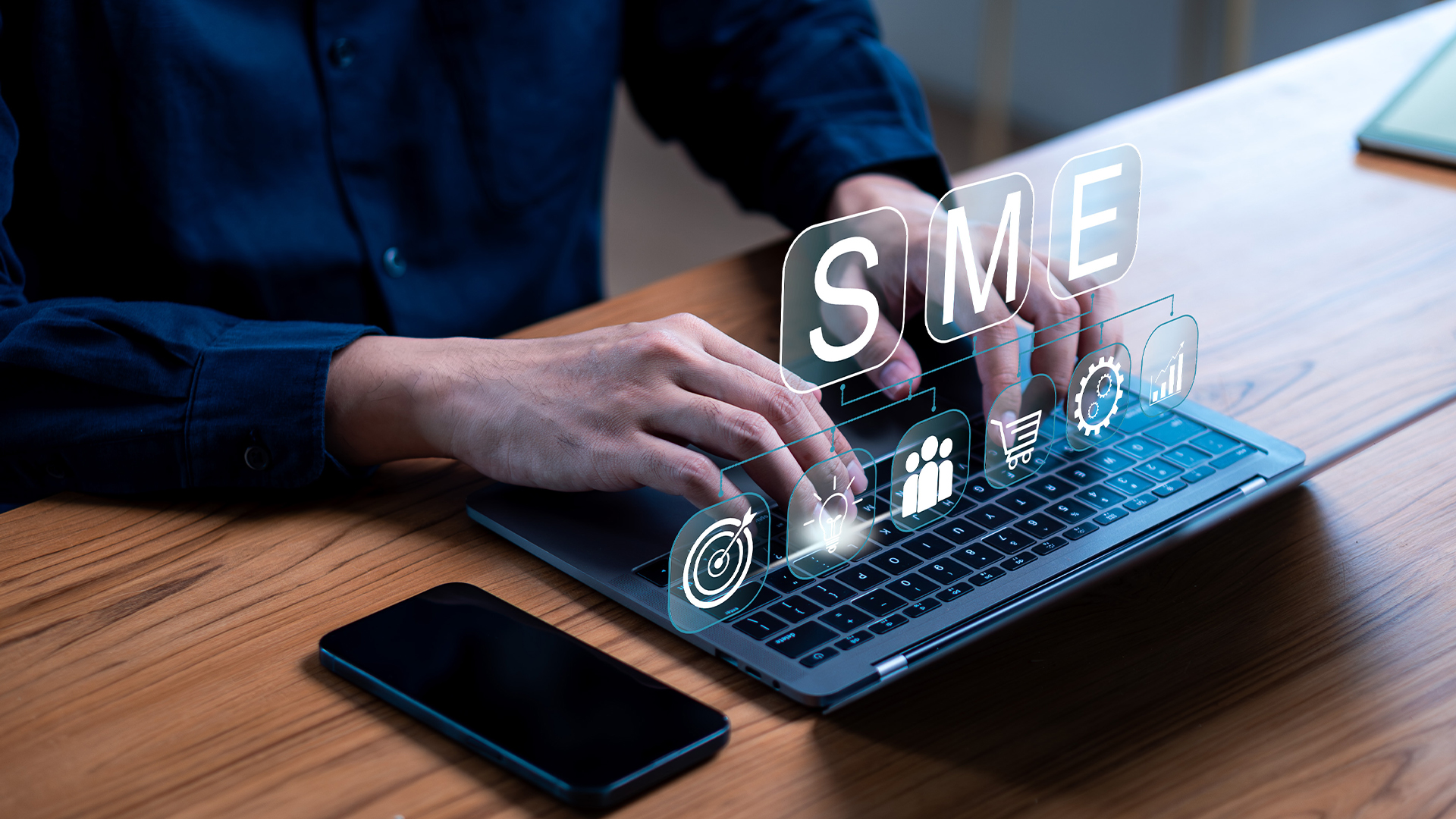 SME business on a laptop with hands for technology strategy.