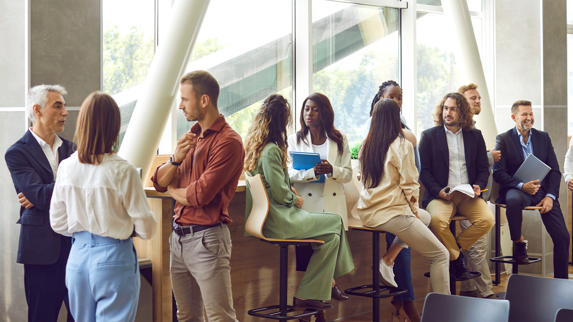 Diverse business professionals communicating at a conference, seminar or other educational event.