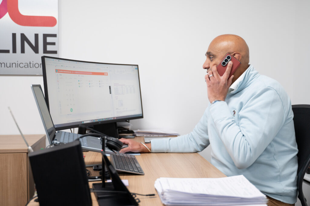 Director and co-founder of Crystaline, Jeteer Pinder, on the phone at his desk. 
