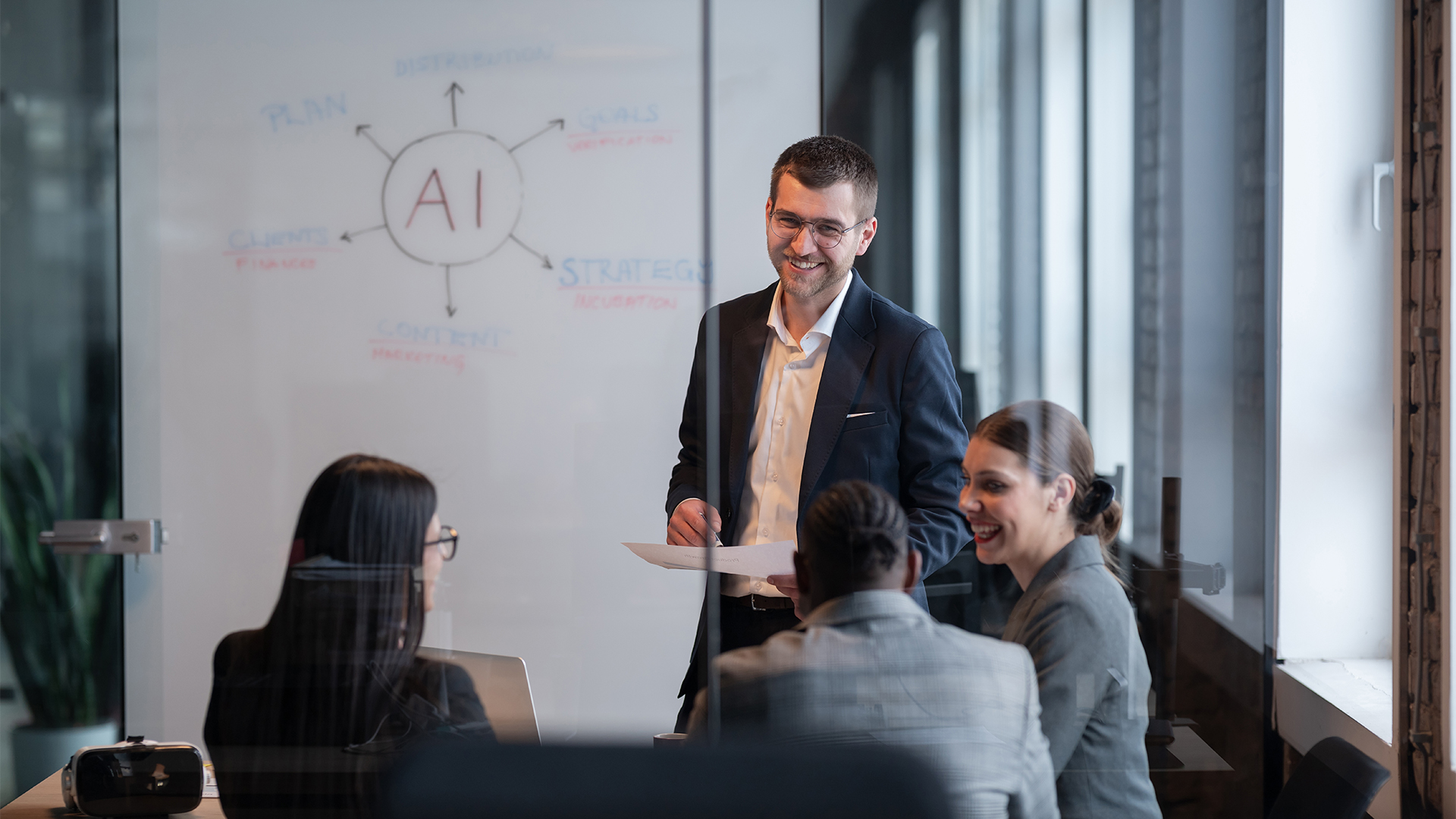 Diverse business team in a modern office during a meeting, discussing artificial intelligence strategy.